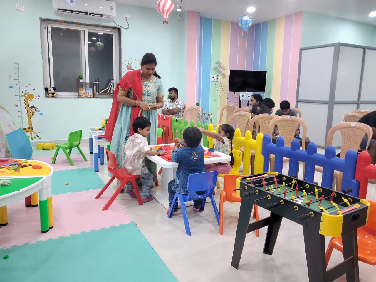 Children enjoying seated activities inside Cocomelos party area